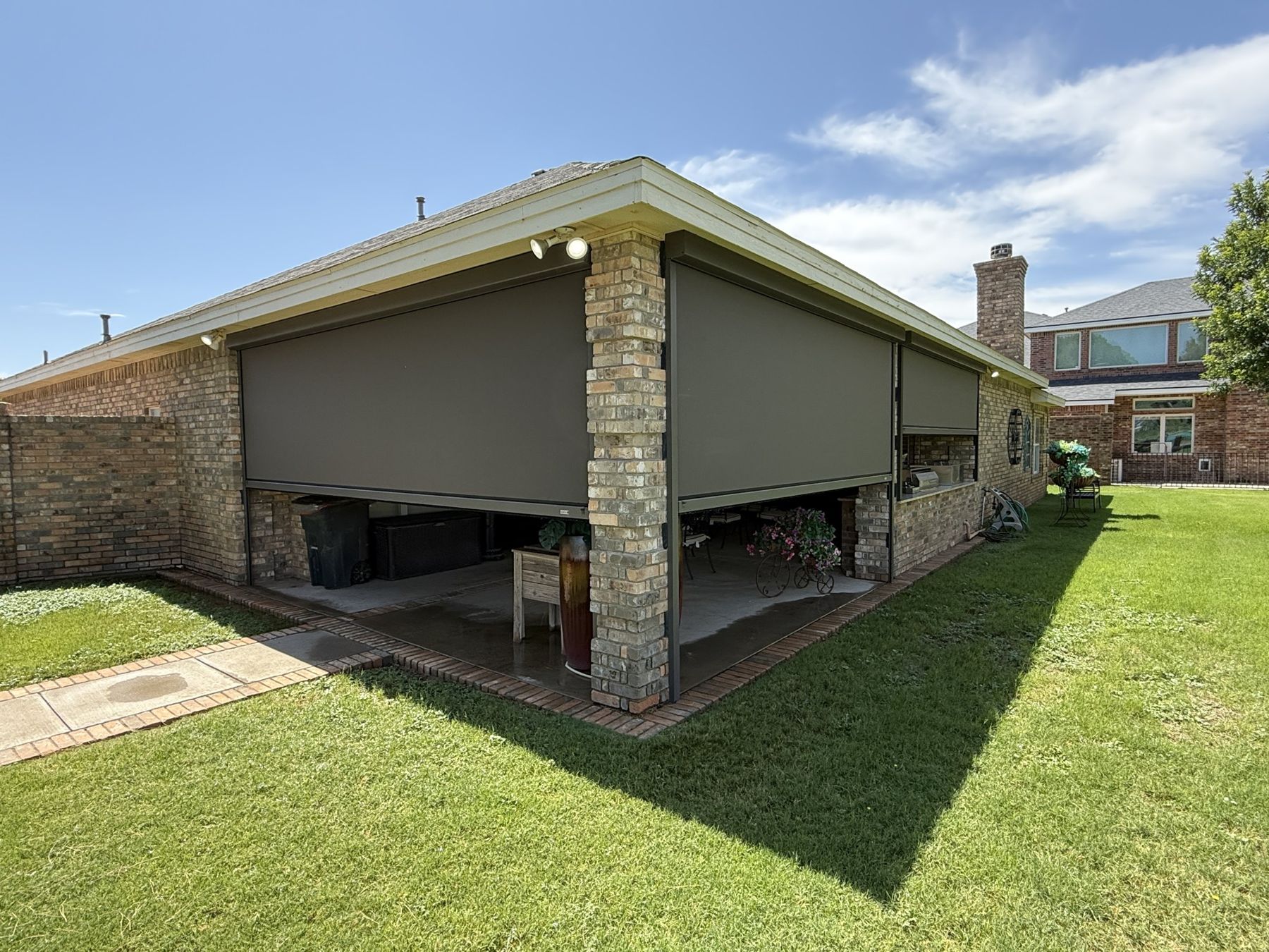 Corner patio screens on a brick home