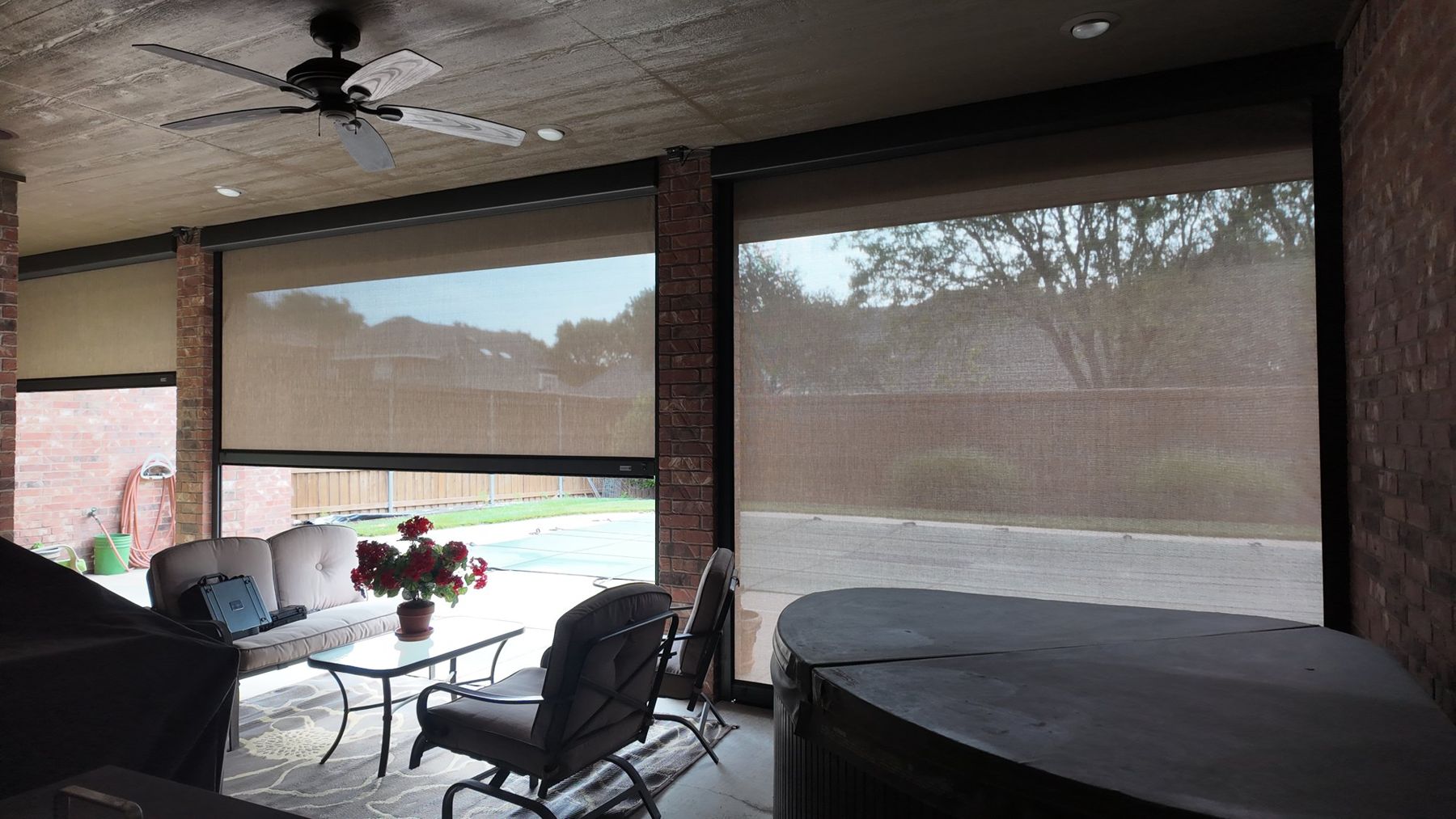View through tan screens over a hot tub patio